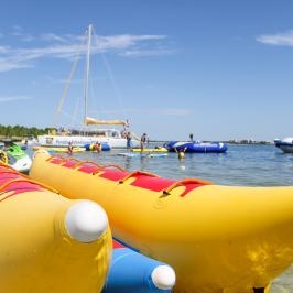 a yellow boat sitting on top of a body of water
